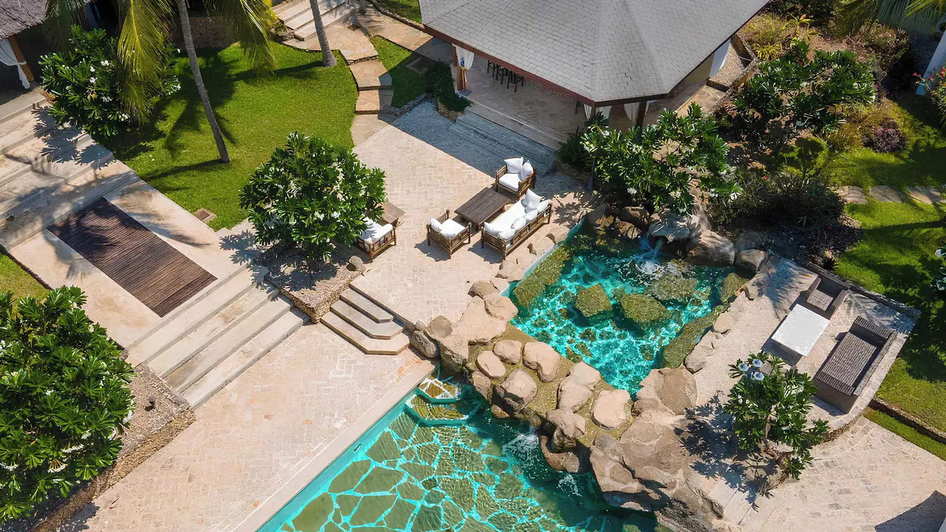 Rock-lined pool and tropical gardens at Lion in the Sun in Malindi