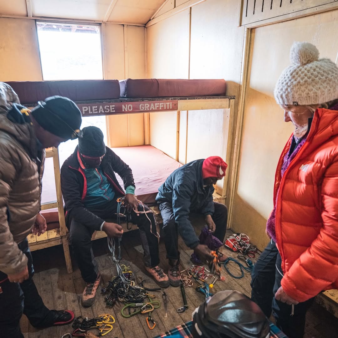 Wilderness Alternative guests and mountain team preparing equipment inside Shipton's Camp