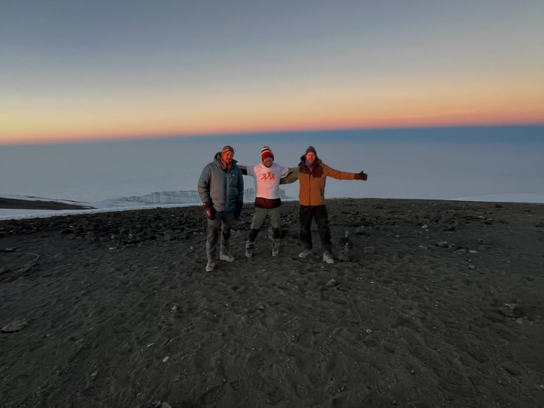 WAE climbers at dawn above the cloud layer on Mount Kilimanjaro