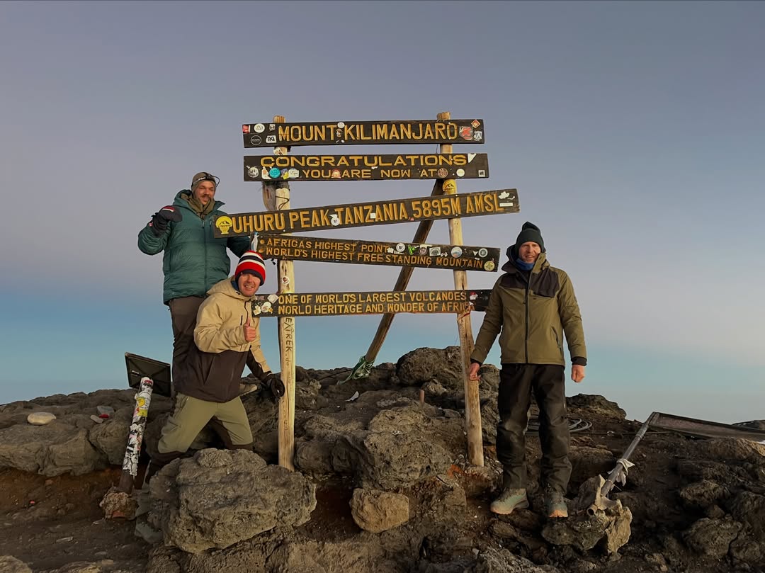 WAE guests at Uhuru Peak after climbing Mount Kilimanjaro