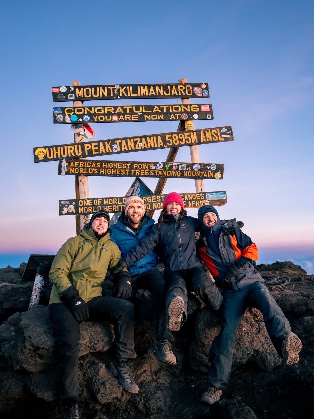 WAE climbers celebrating together at Uhuru Peak