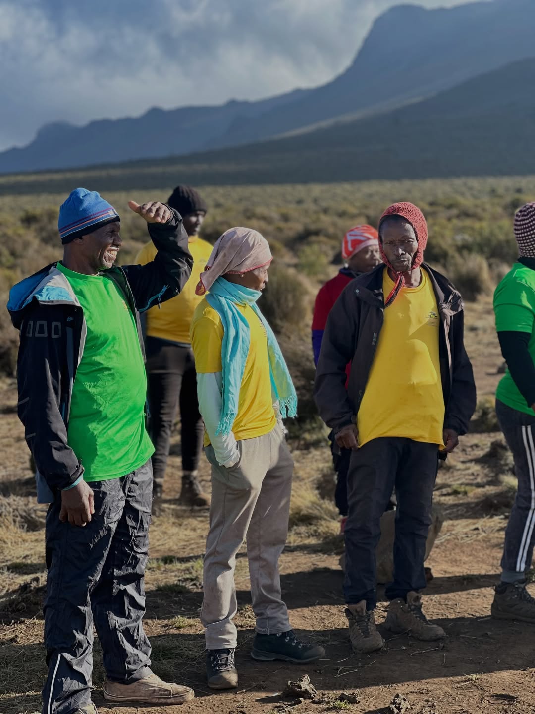 Local Kilimanjaro mountain crew gathered beneath the northern landscape