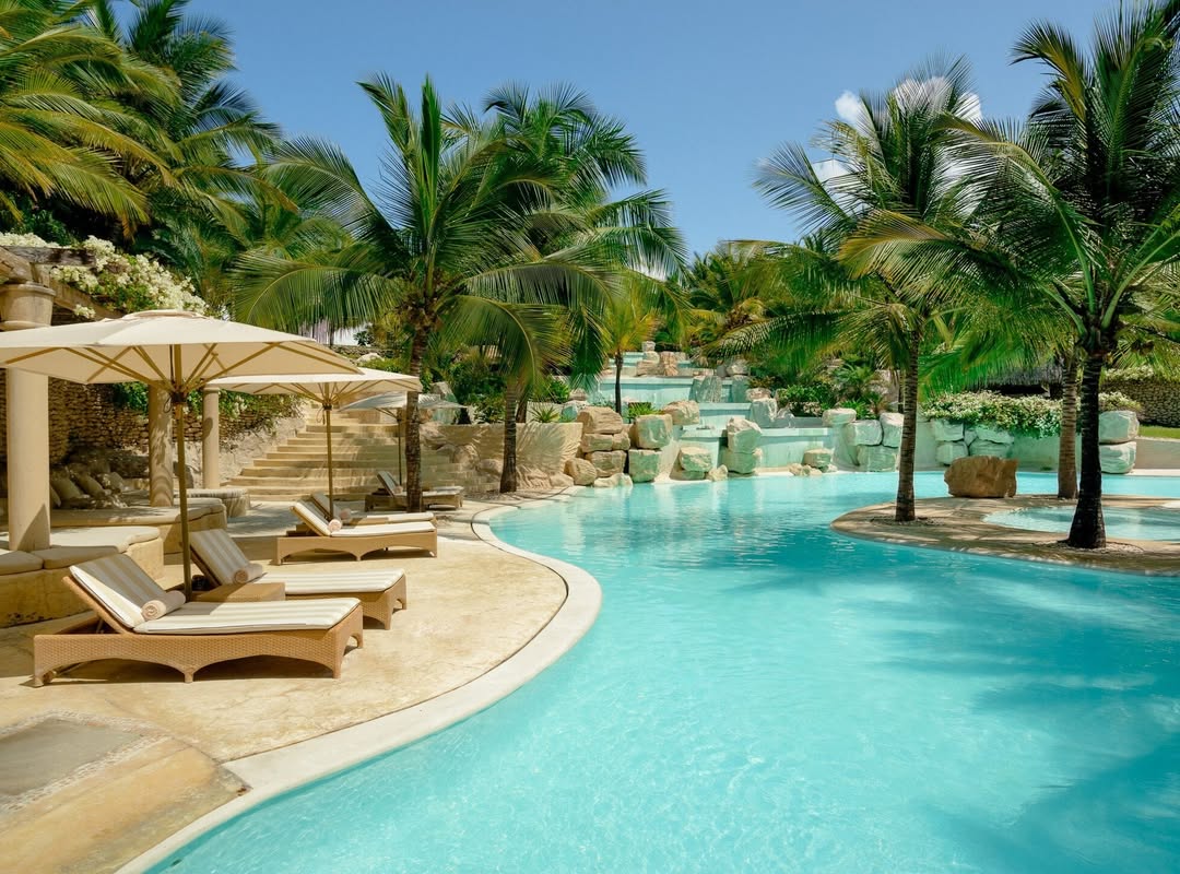 Cascading turquoise pool and palm gardens at Swahili Beach in Diani