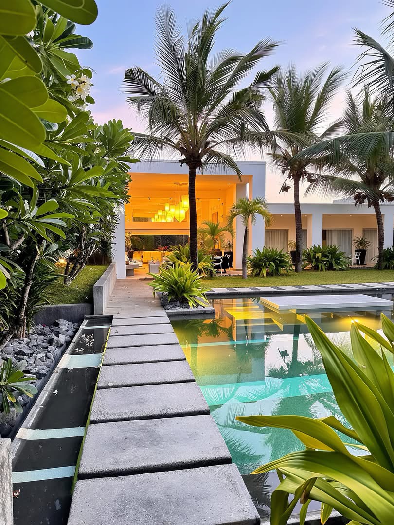 Contemporary private villa and pool among tropical gardens