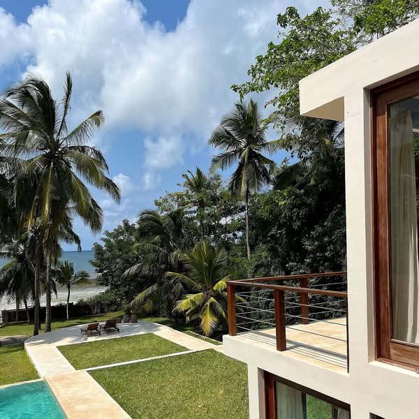Contemporary coastal accommodation framed by palms near the Indian Ocean