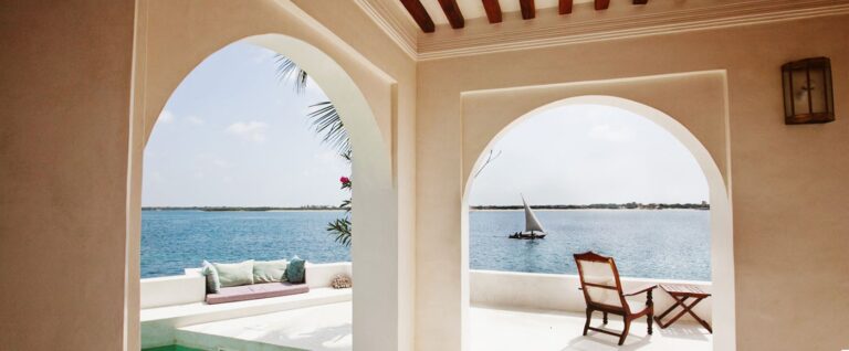 Sea-facing arches and a dhow at Forodhani House on Shela Beach