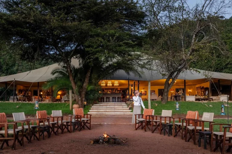 Cottar's 1920s Camp main mess tent and lantern-lit fire circle in Olderkesi Conservancy.