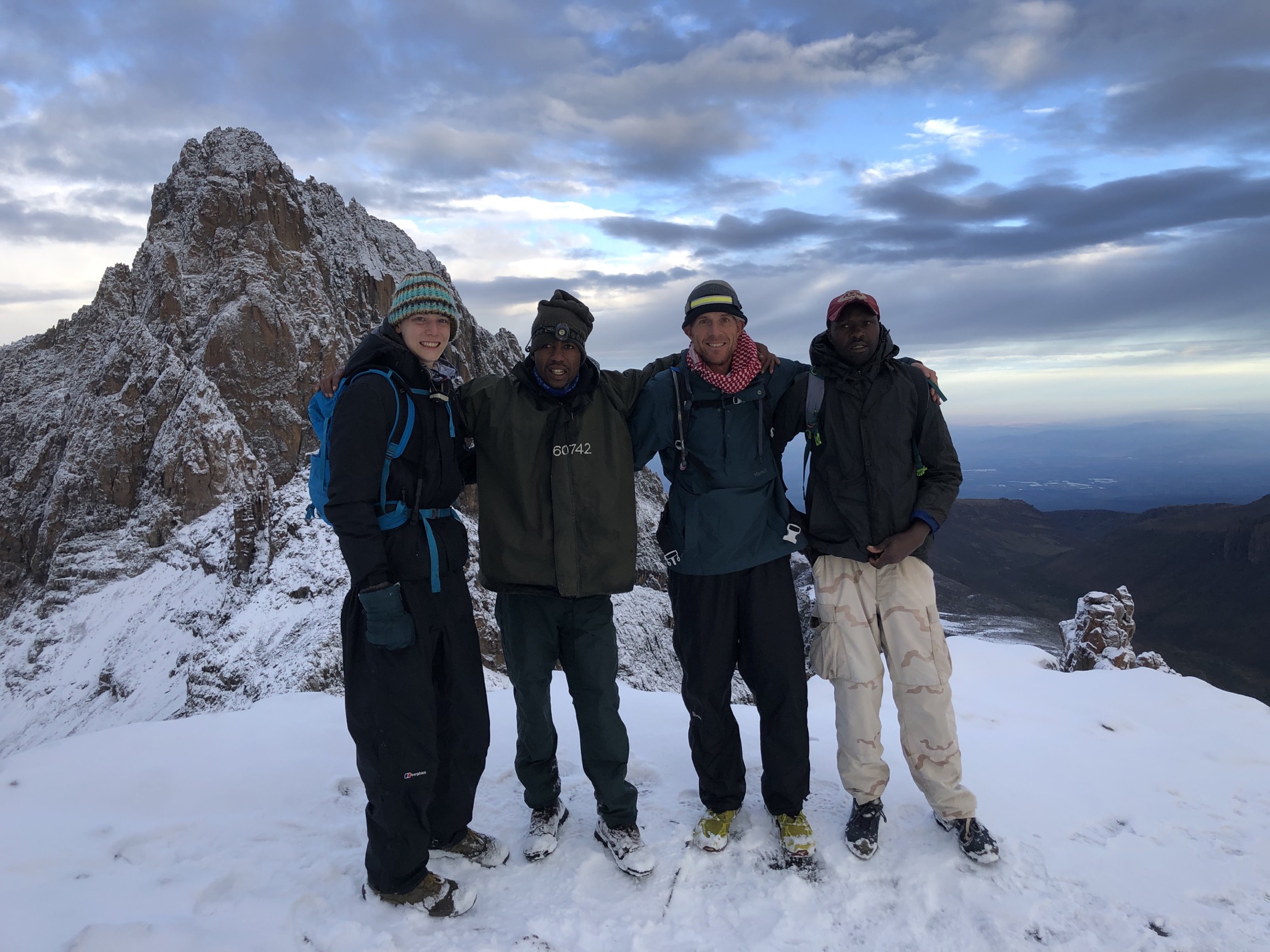 Joseph Kimani with guests and colleagues in the snow on Mount Kenya