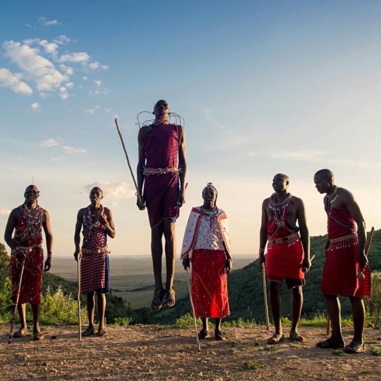 Maasai hosts performing a traditional jumping dance during a community visit