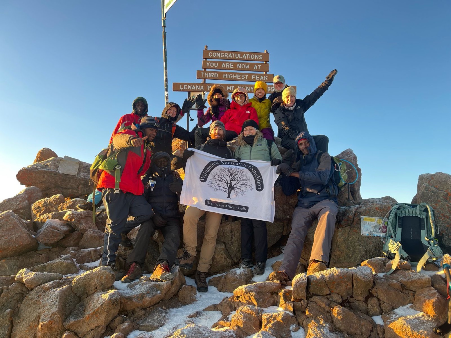 Wilderness Alternative guests and crew celebrating on Point Lenana, Mount Kenya