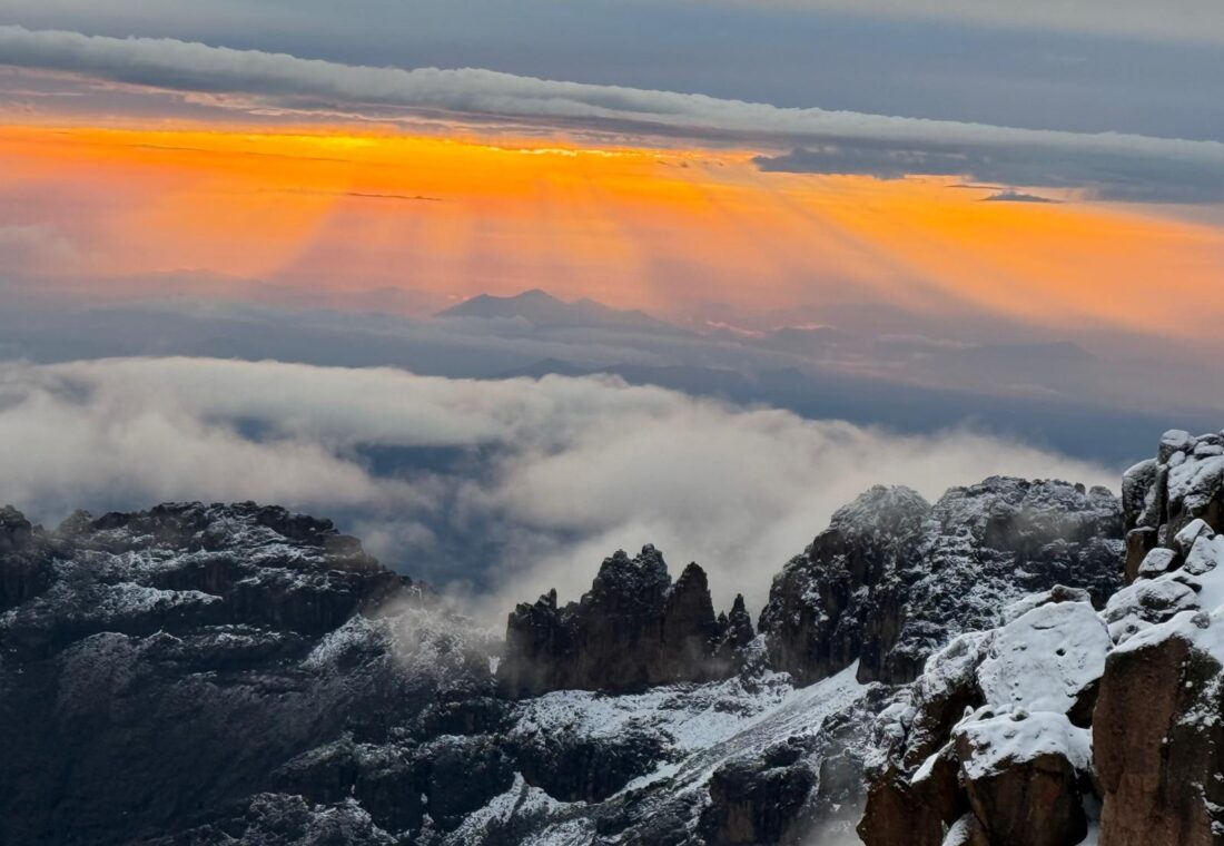 Sunrise above snowy Mount Kenya ridges and clouds