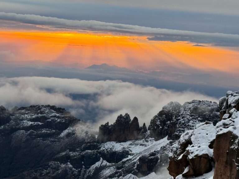 Sunrise above snowy Mount Kenya ridges and clouds