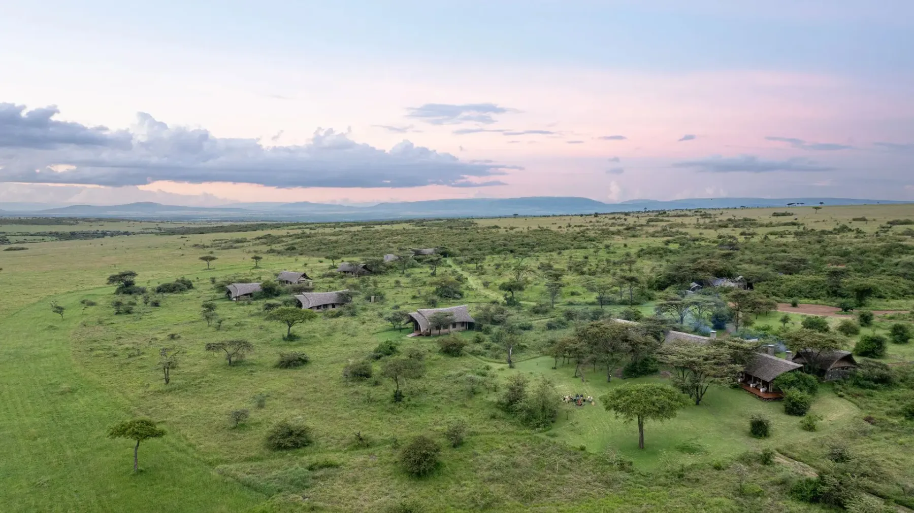 Naboisho Camp spread across the open grasslands of the Mara Naboisho Conservancy.