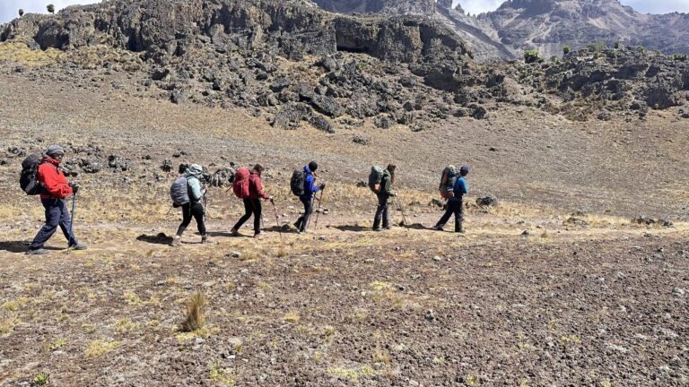A guided trekking group crossing Mount Kenya’s high alpine terrain