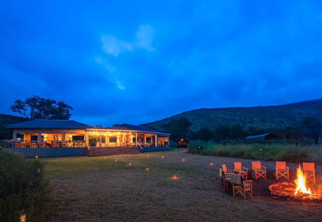 Dunia Camp glowing at blue hour in the central Serengeti