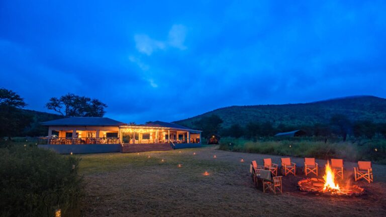 Dunia Camp glowing at blue hour in the central Serengeti